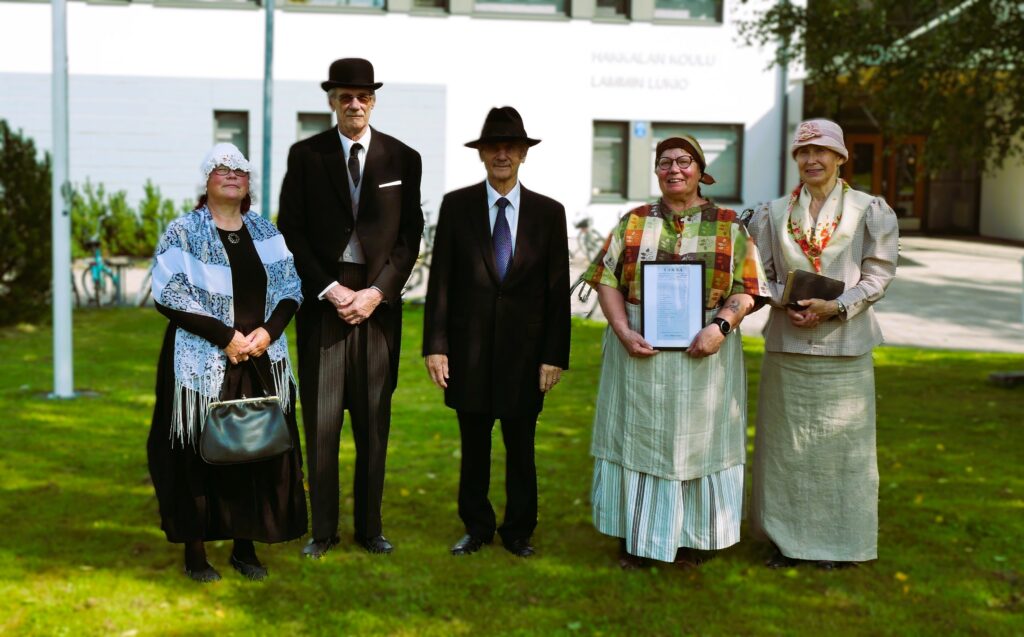 opiskelijoita vanhan ajan vaatteissa